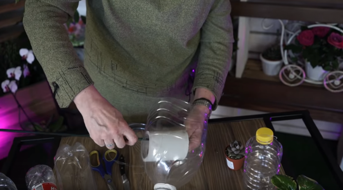 Mettez maintenant un rouleau de papier toilette dans la moitié de la bouteille de manière à ce que le bâton soit à l'intérieur de la bobine.